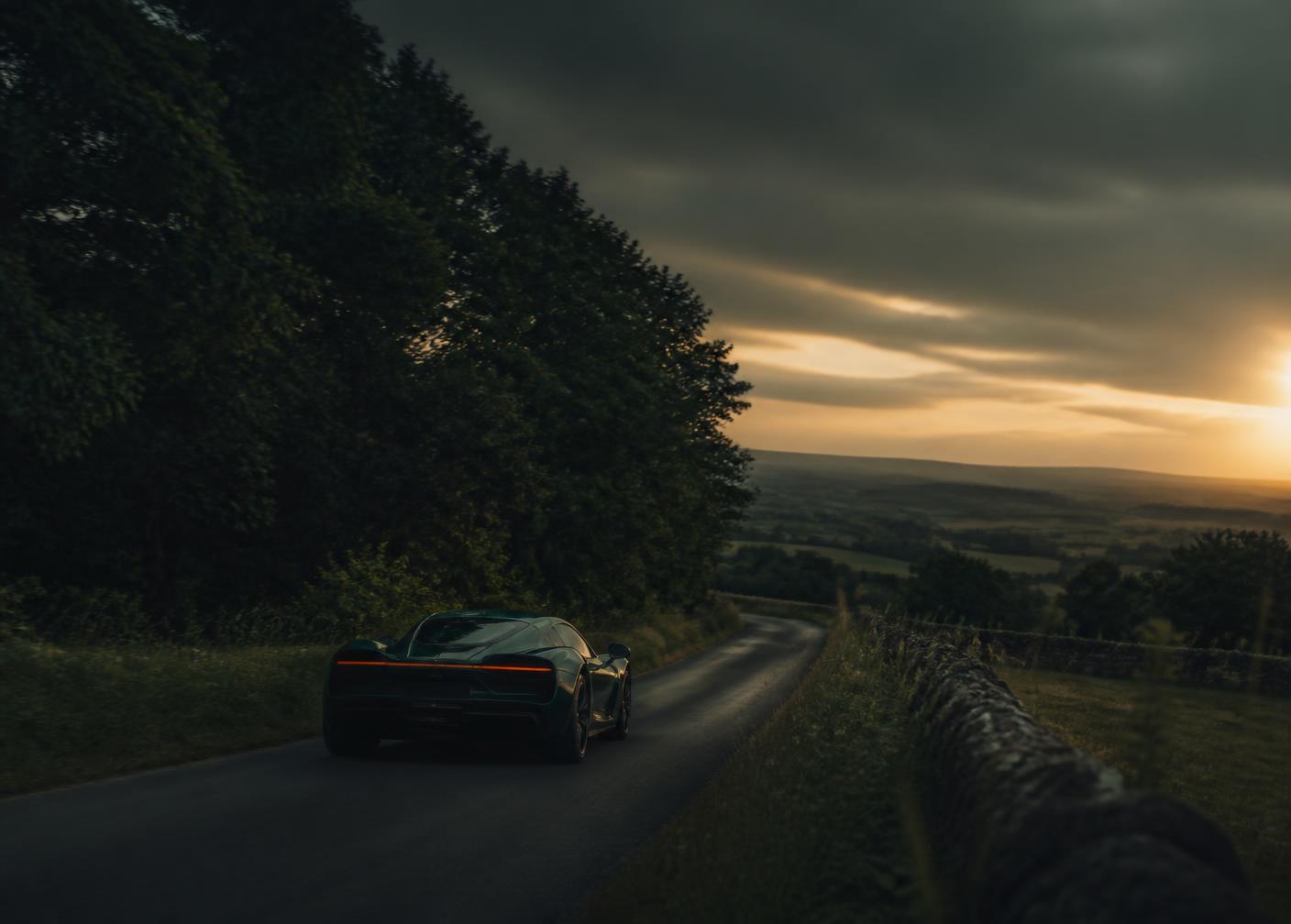 An exotic car on a private English road at dusk